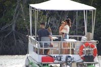 Young family with 2 adults and 2 toddlers enjoying a day out on the Trinity Inlet