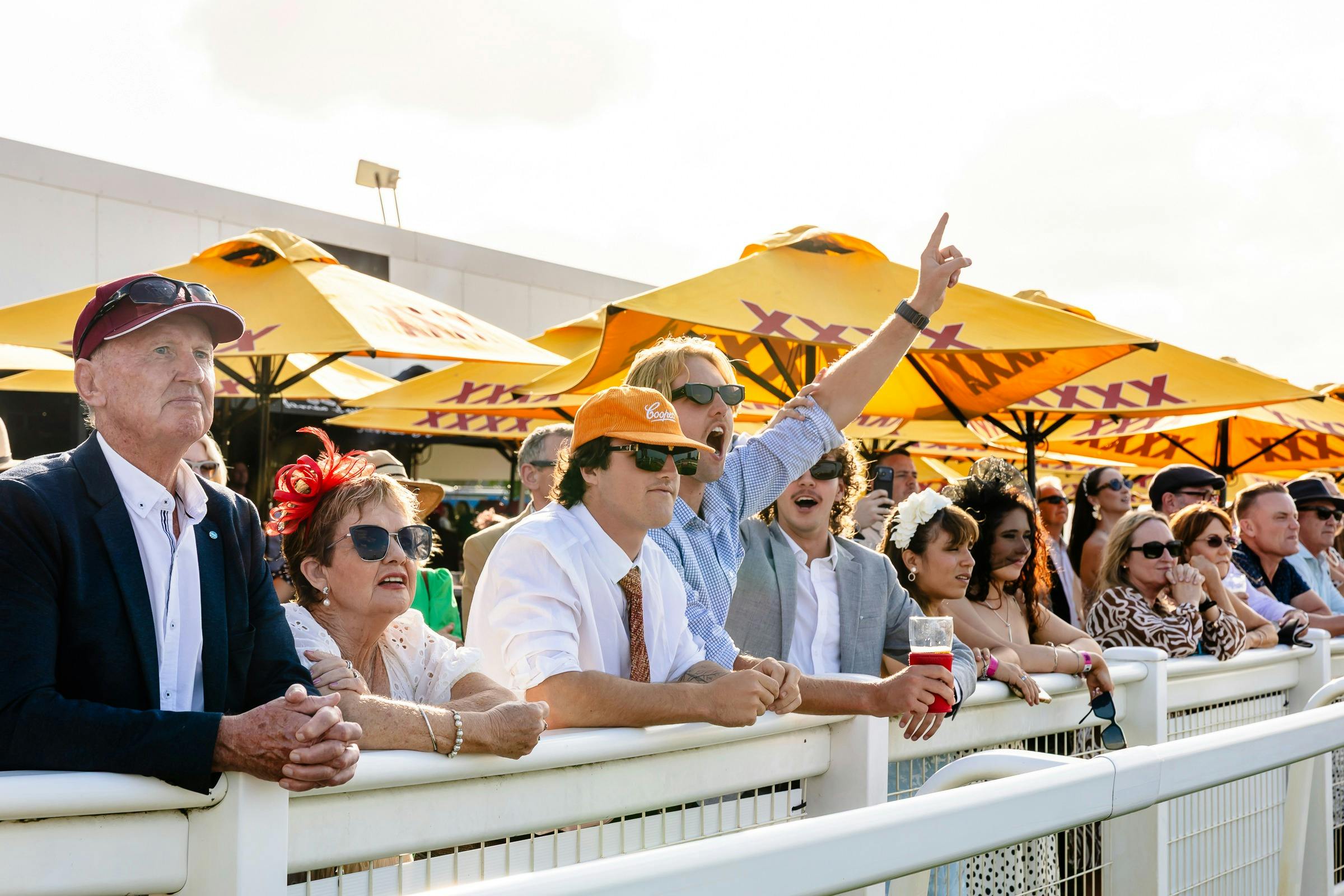 Racegoers celebrate a win trackside at Doomben Racecourse on Keith Noud Stakes Day