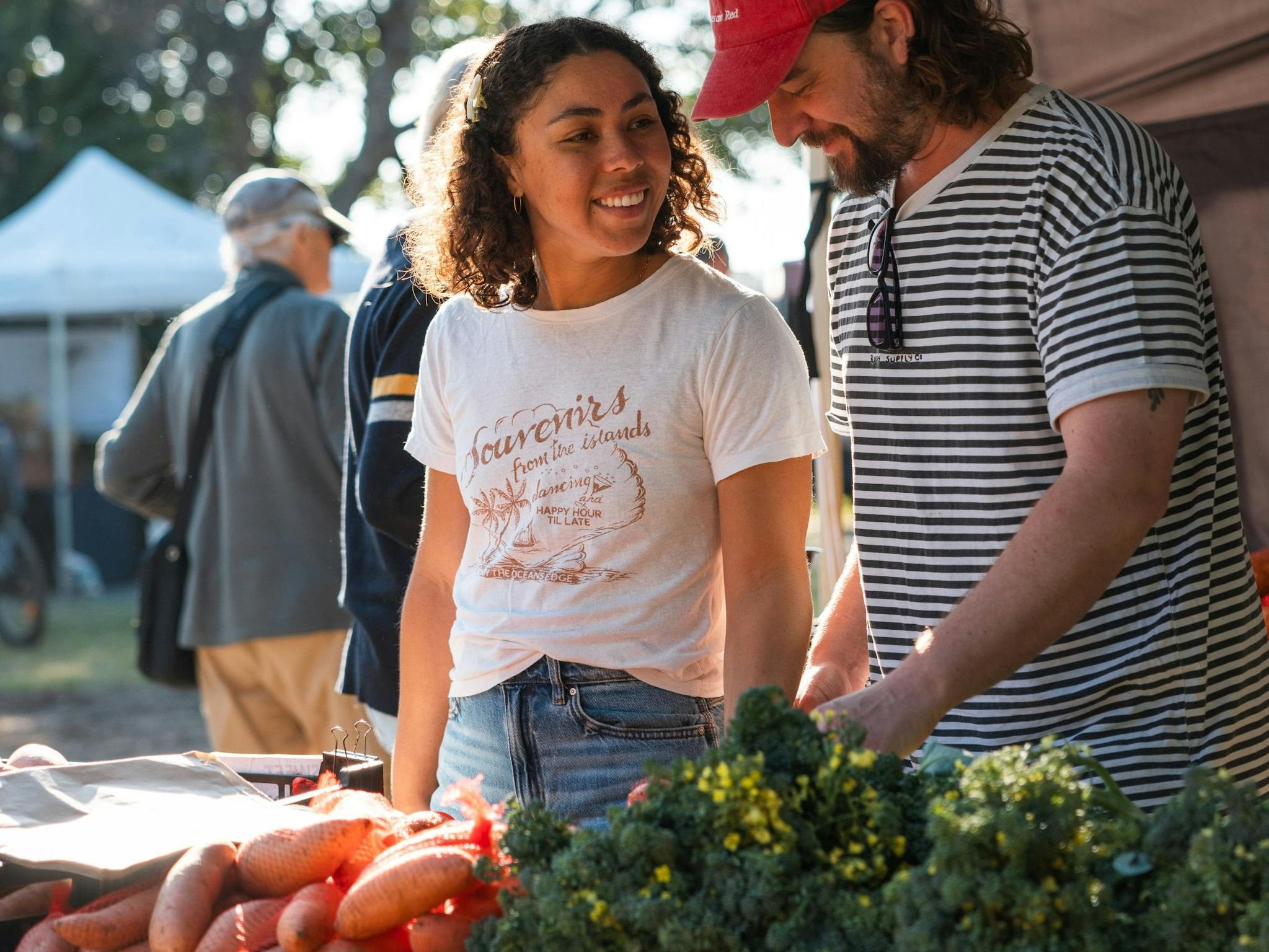 Image of a young couple looking at fresh produce on sale