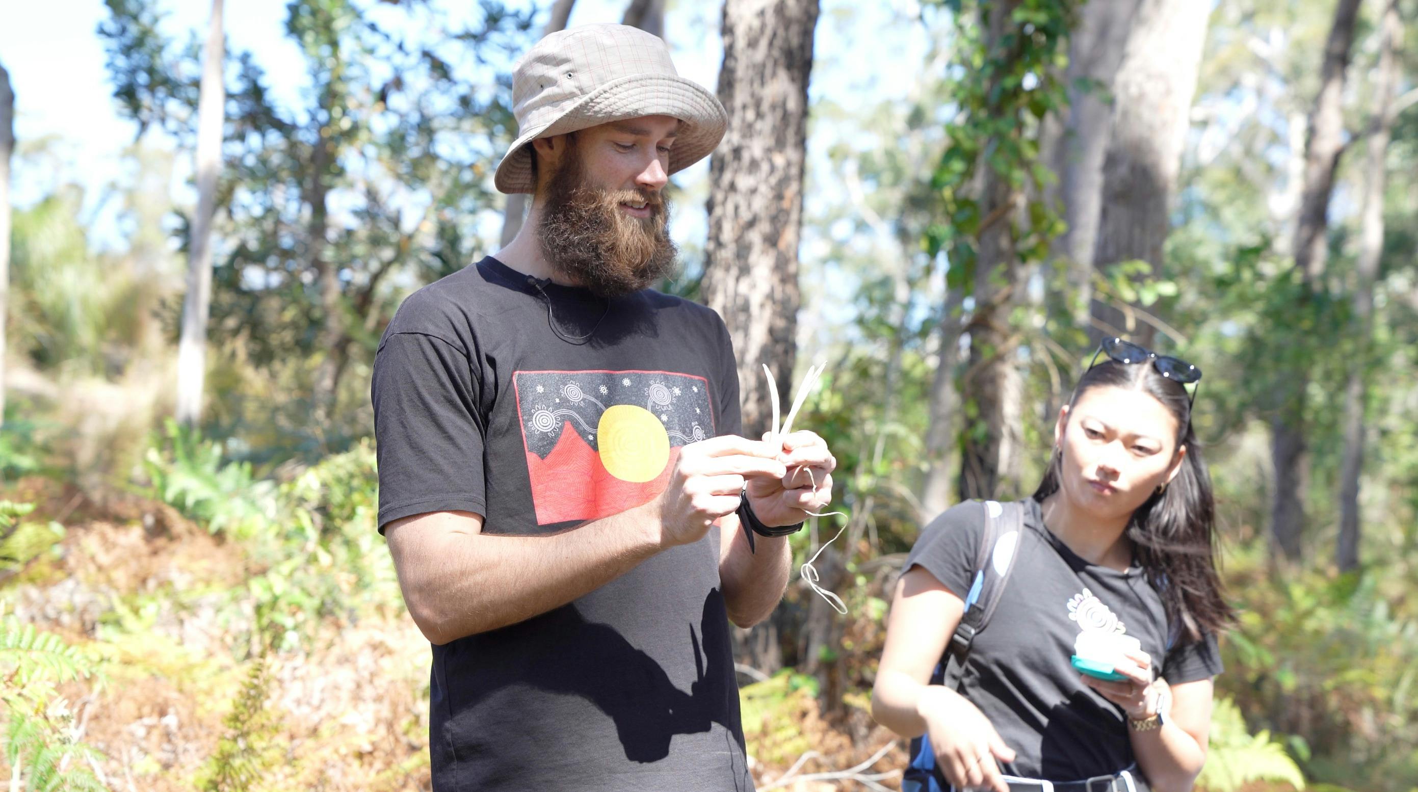 Felix showing how to make traditional Aboriginal fishing spear with kangaroo bones