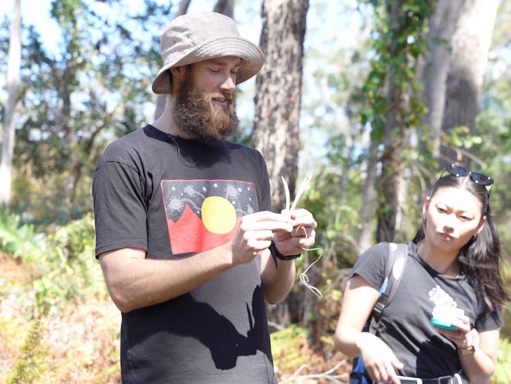 Felix showing how to make traditional Aboriginal fishing spear with kangaroo bones