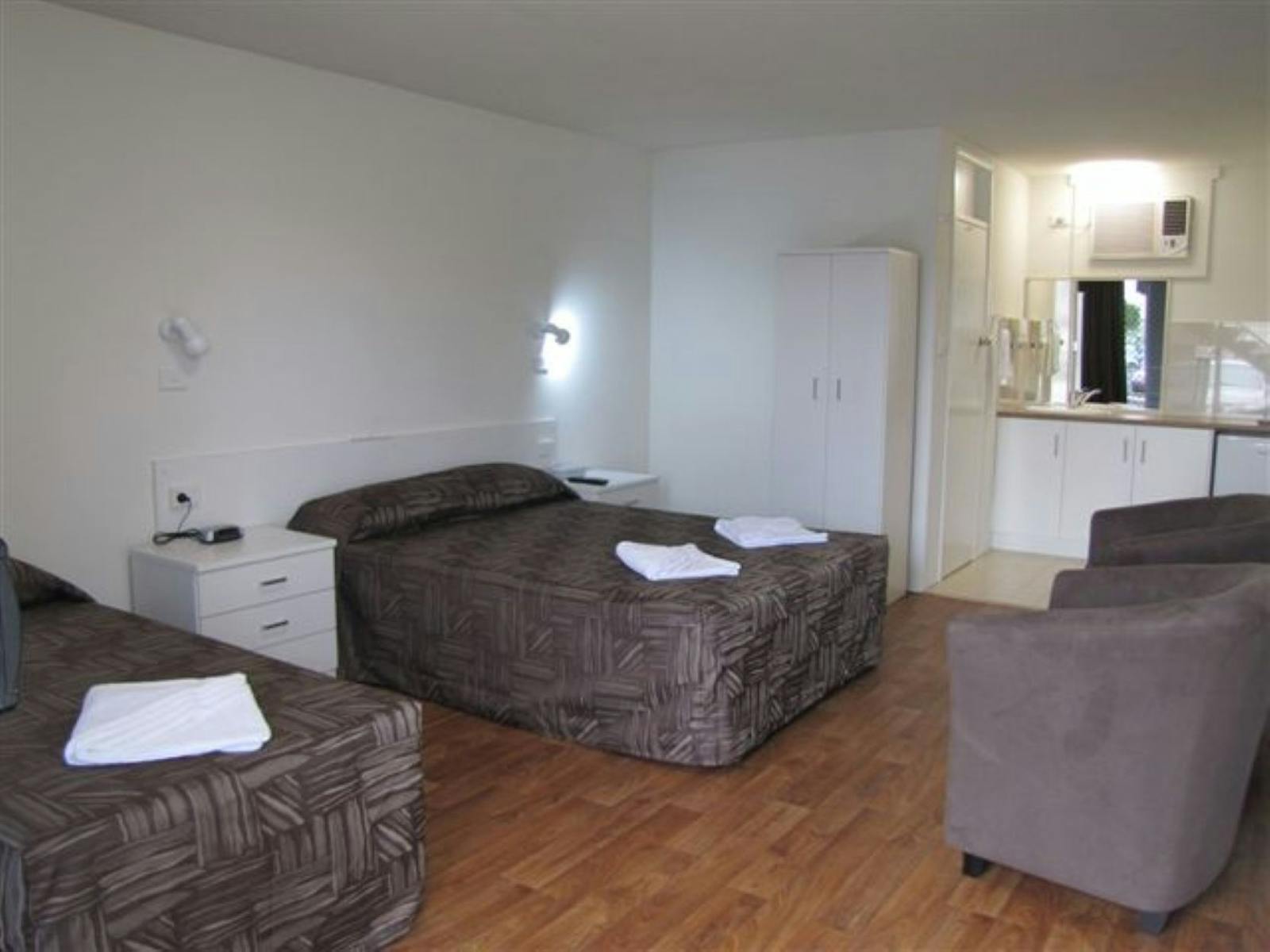Two beds with a kitchenette