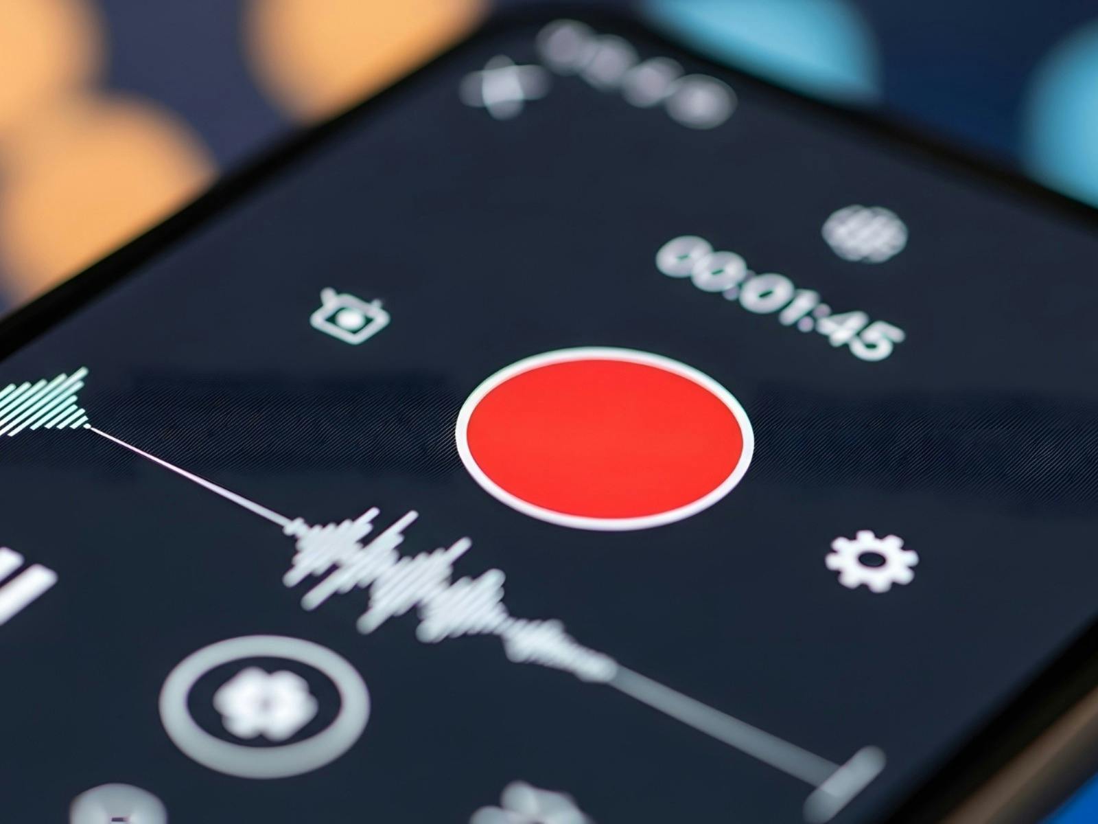 Close-up of a smartphone screen displaying a media player interface with a prominent record button.