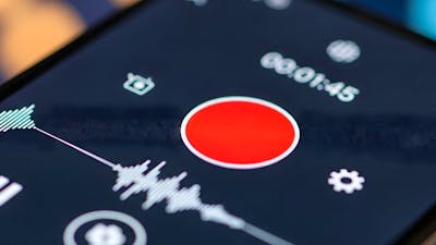 Close-up of a smartphone screen displaying a media player interface with a prominent record button.
