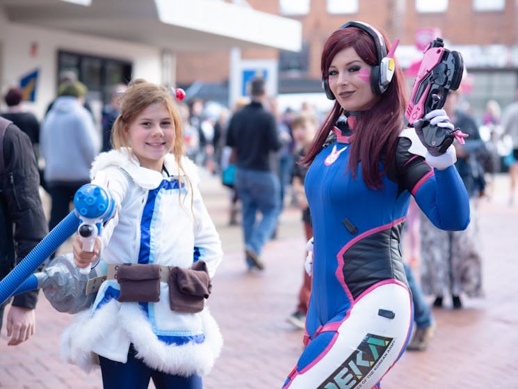 Two cosplayers pose for a photo