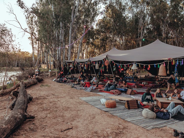 People relaxing at the Mirage Motel Bedouin tent looking out on to the River Murray