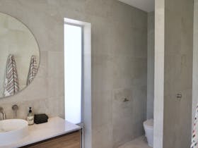 Ensuite bathroom with stone tiles and walk in shower