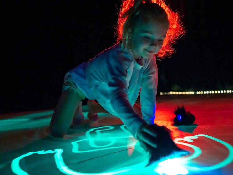 child illuminated by blue light