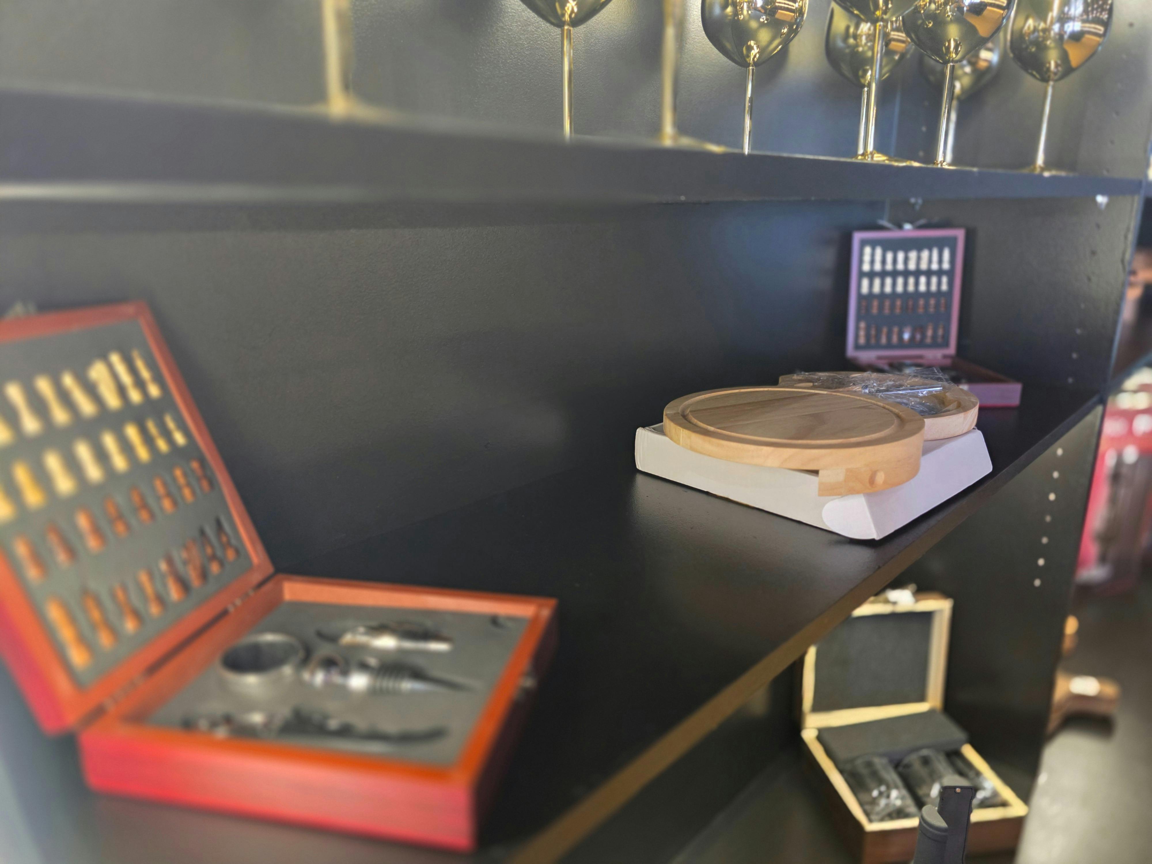 Display of serving boards and cheese accessories in The Gift Cellar.