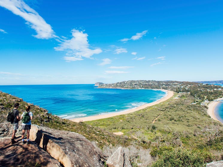 Walk guests enjoying scenic coastal hike on Barrenjoey headland in Palm Beach, Sydney
