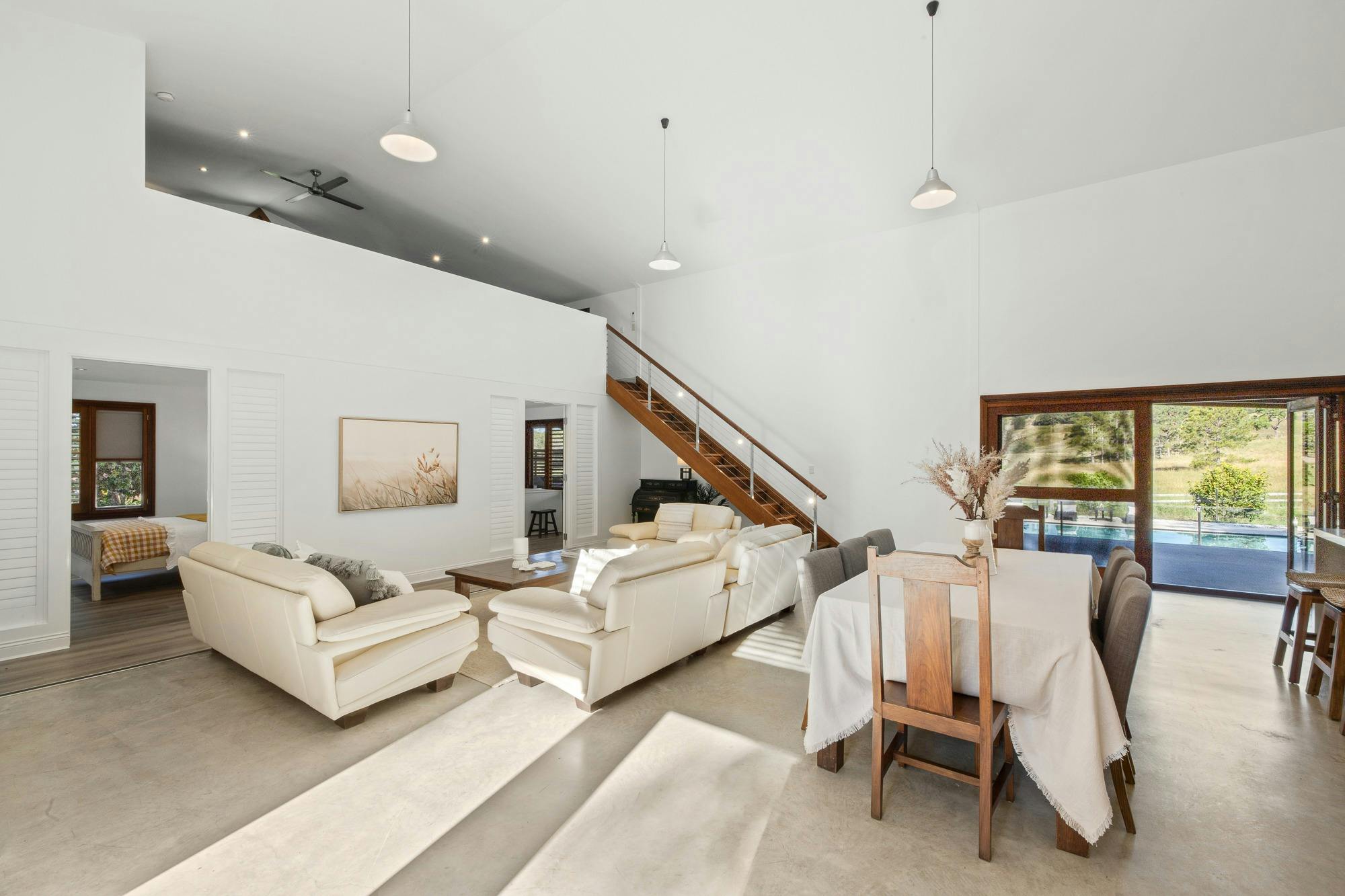 Open-plan living area with modern decor, cozy seating, and natural light