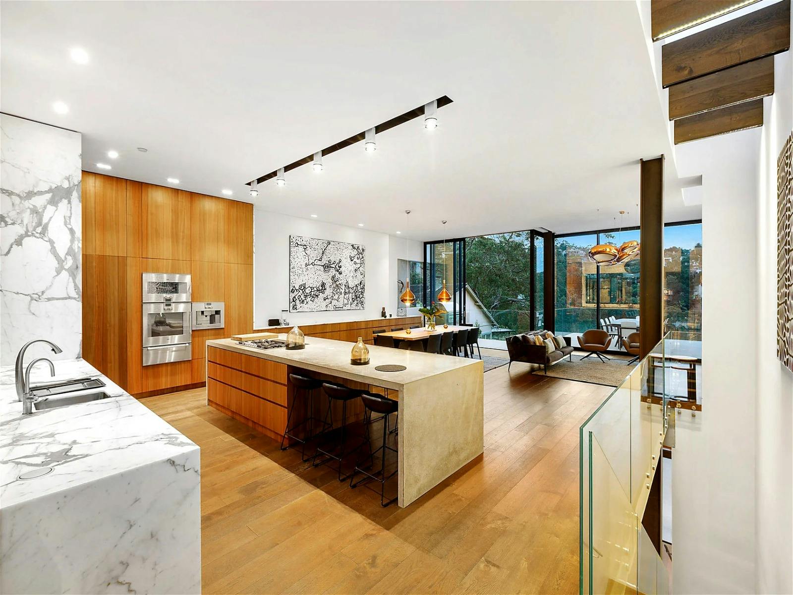 open plan kitchen and dining area that flows out onto the sunny deck in the rear pavilion