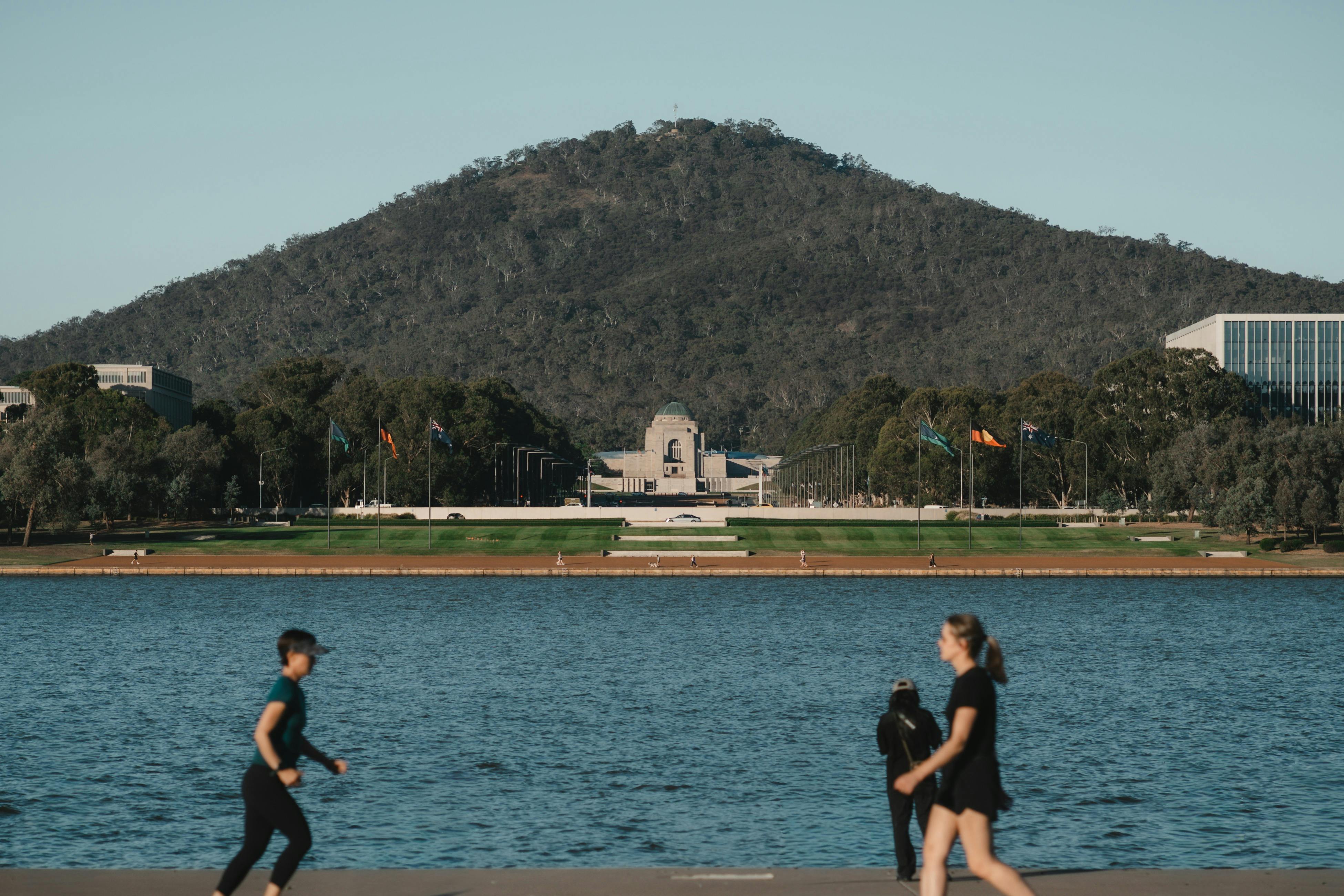 A lake with a memorial in the background