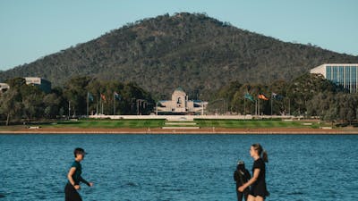 A lake with a memorial in the background