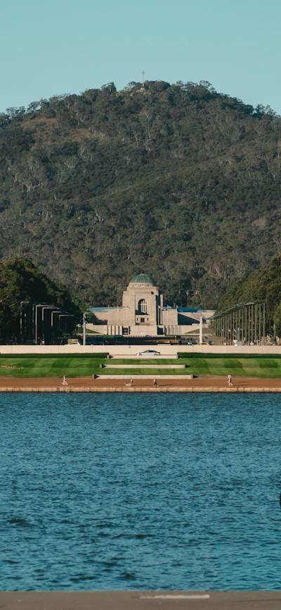 A lake with a memorial in the background