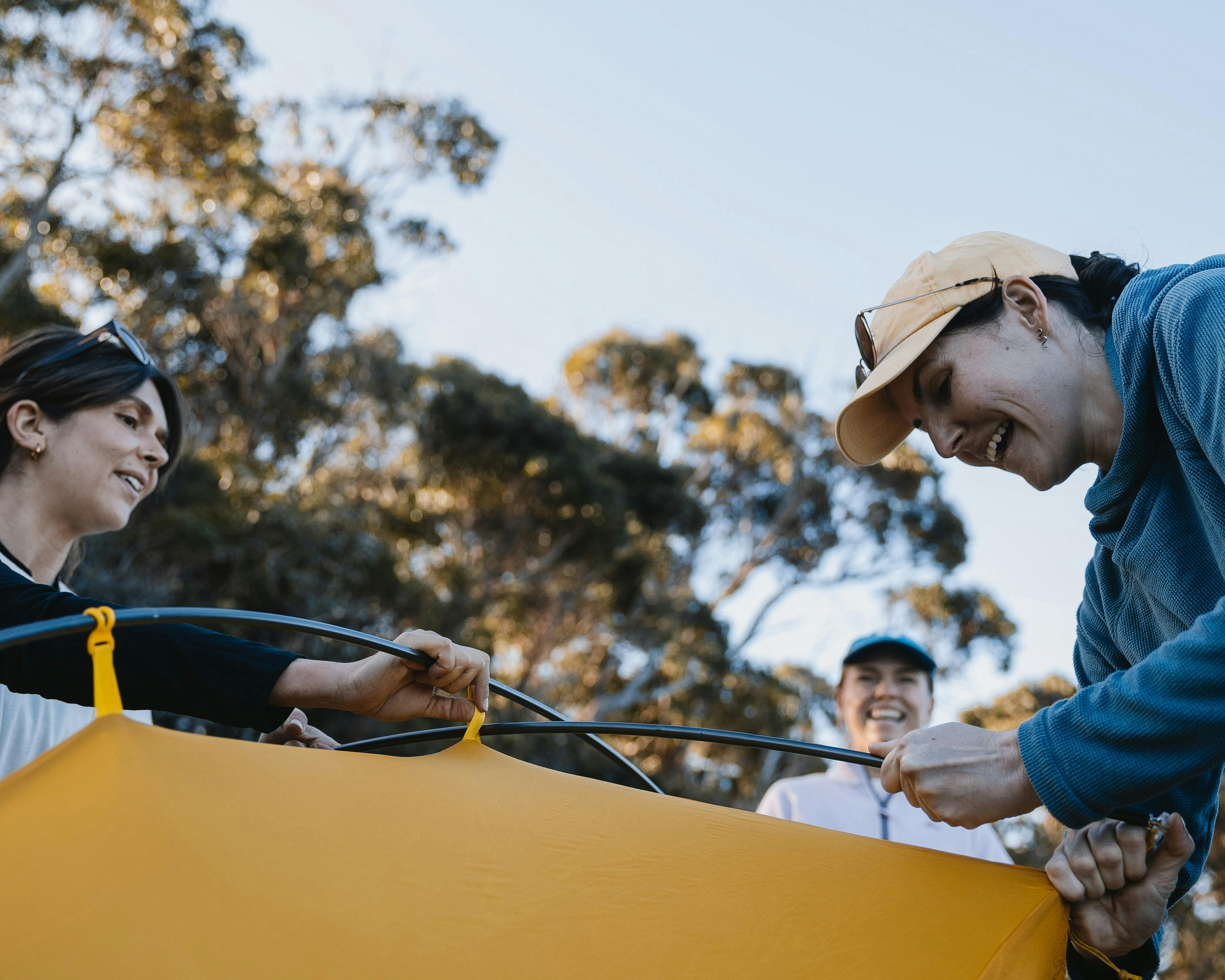 Women setting up a tent and learning the skills to multi-day hiking