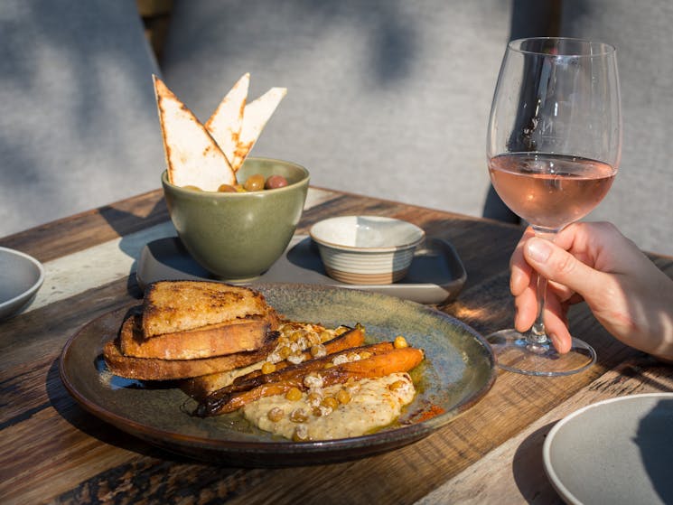 Hummus topped with roasted chickpeas & heirloom carrots, glass of wine, Kangaroo Valley Olives