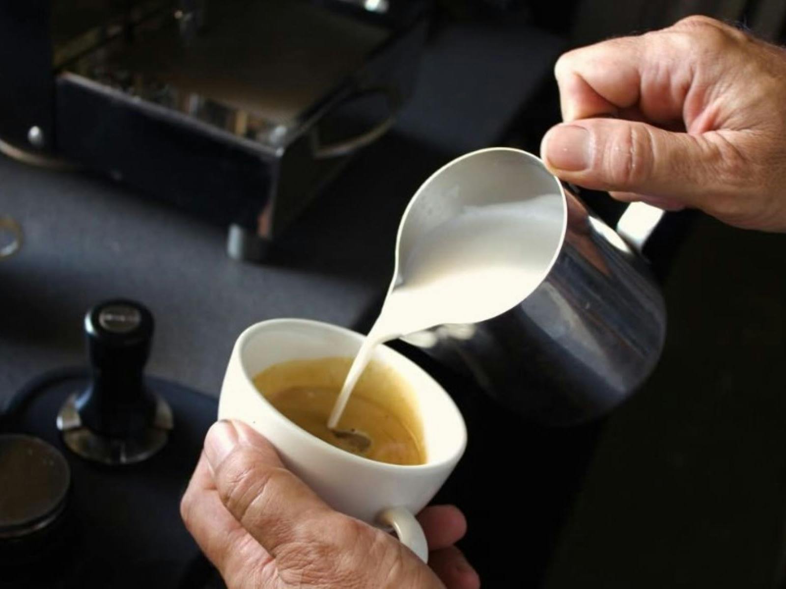 Pouring milk into coffee