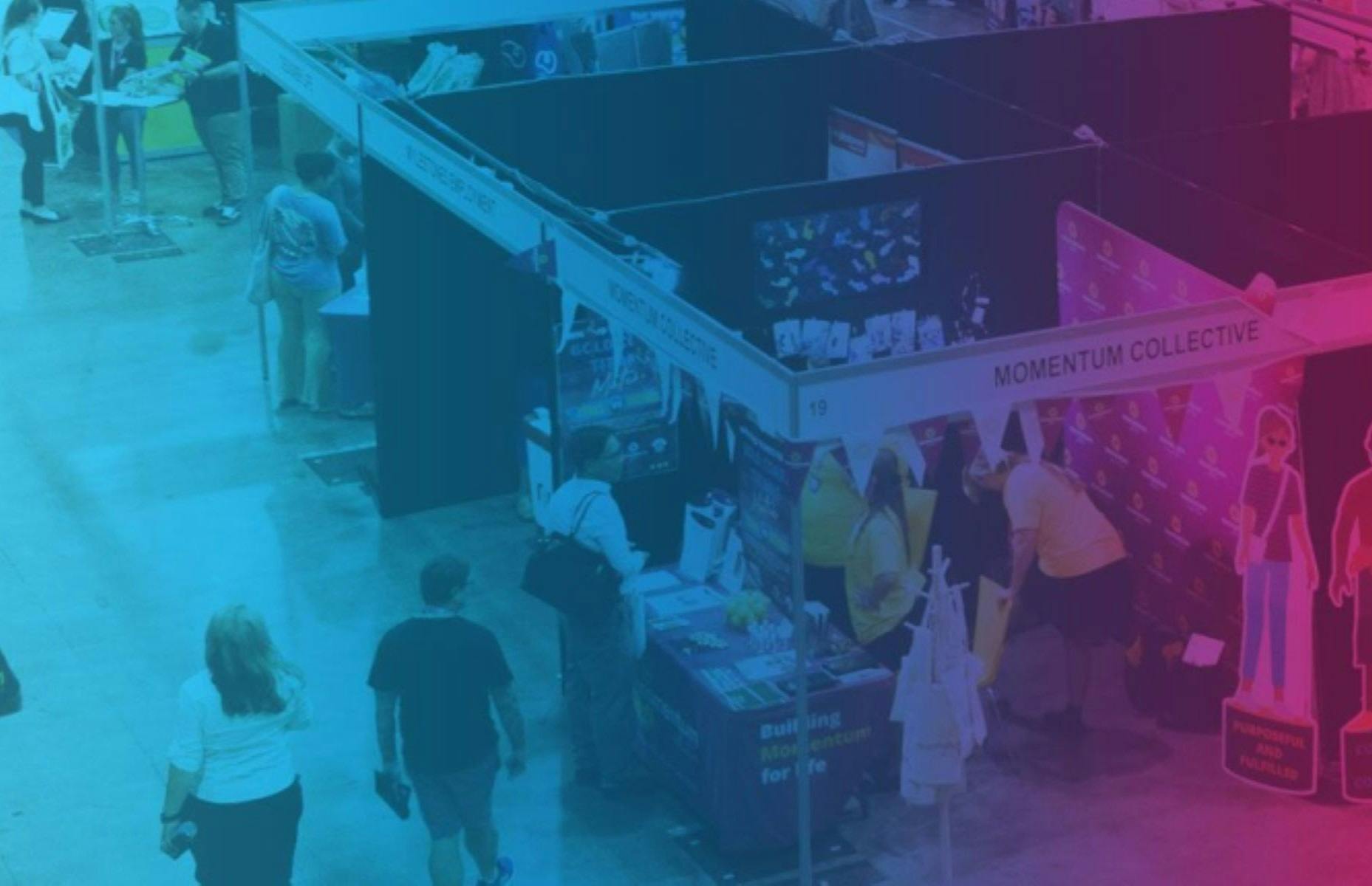 A blue and purple tinted image of a exhibitors stall at the expo