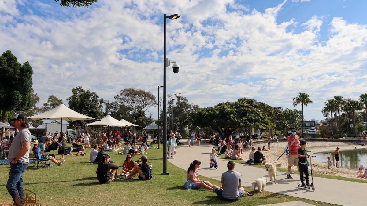 groups of customers sitting on the grass in the sun