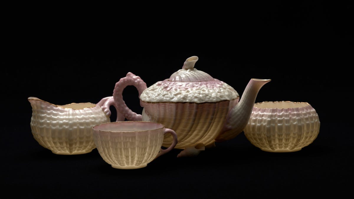 Delicate tea set with ornate cream and pale pink detail Delicate tea set with ornate cream and pale pink detail