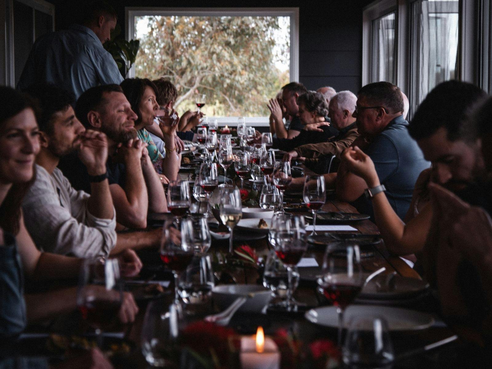 개인 행사에 적합한 스윙잉 브릿지에서 레드와인을 곁들인 저녁 식사를 즐기는 손님들.