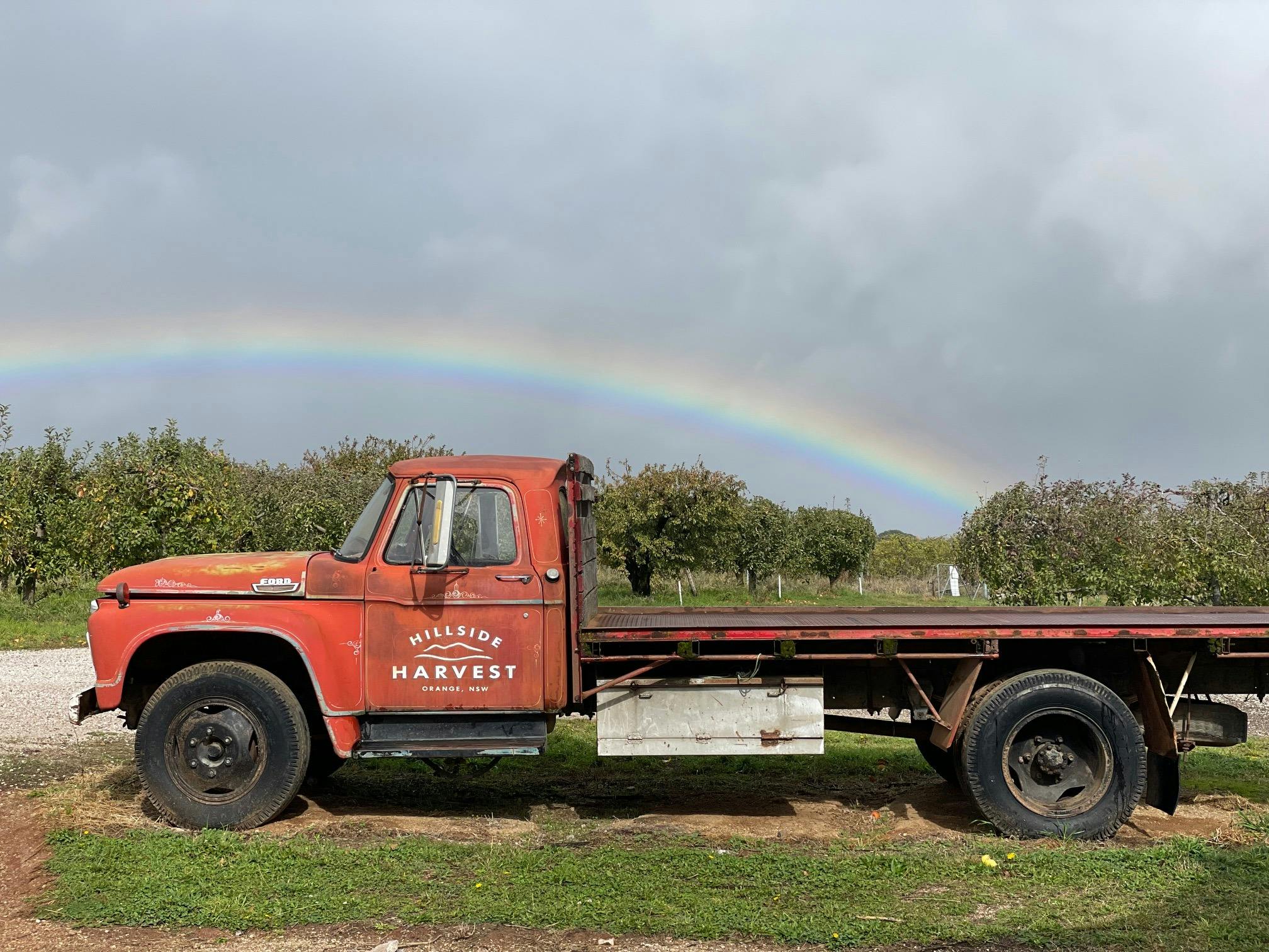 Beautiful rainbow over the Hillside Harvest red truck