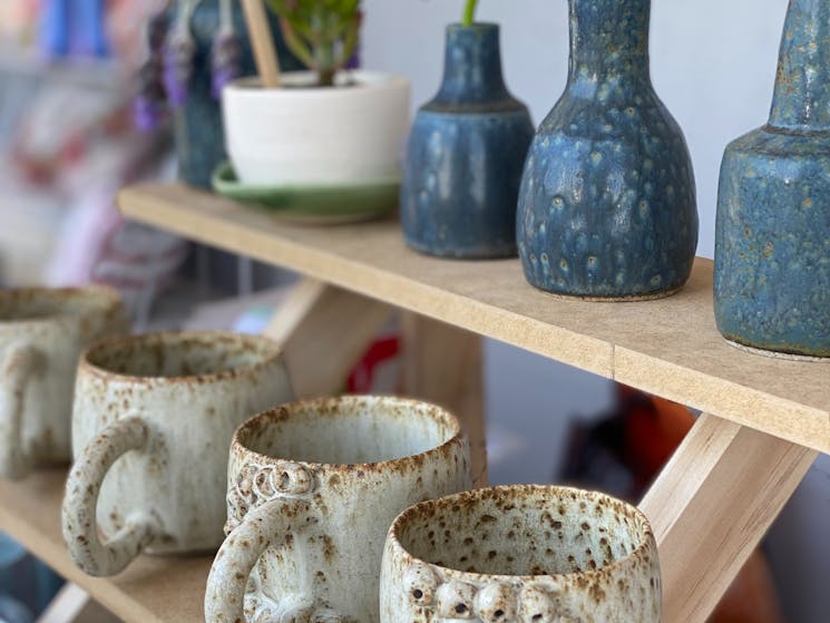 picture shows a shelf of handmade pottery