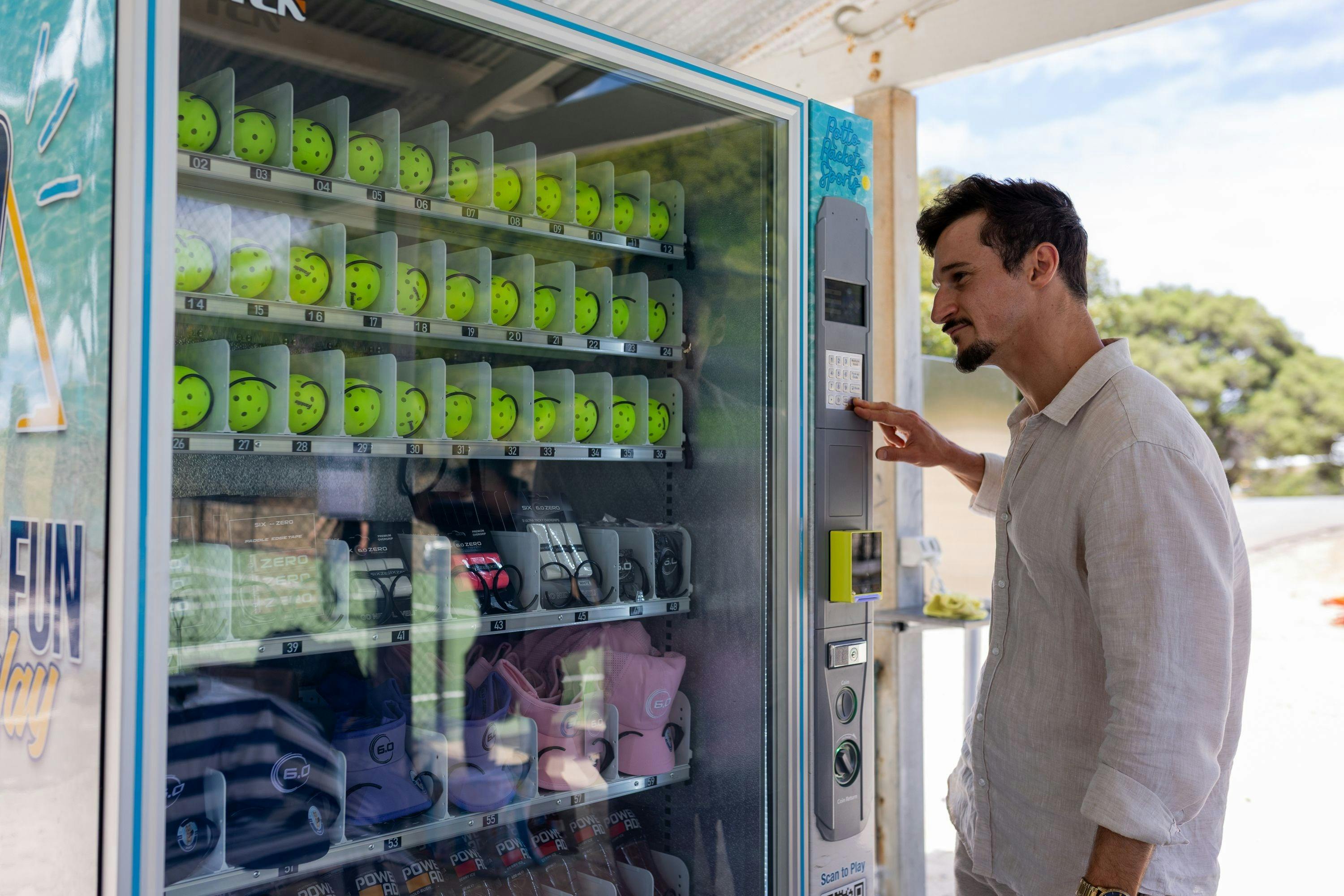 Courtside vending machine with pickleball equipment and refreshments at Rotto Rackets Sports.