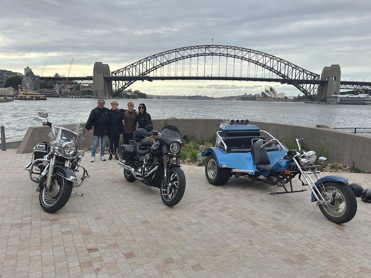 A family Harley and trike tour on the northern side of the Sydney Harbour Bridge.