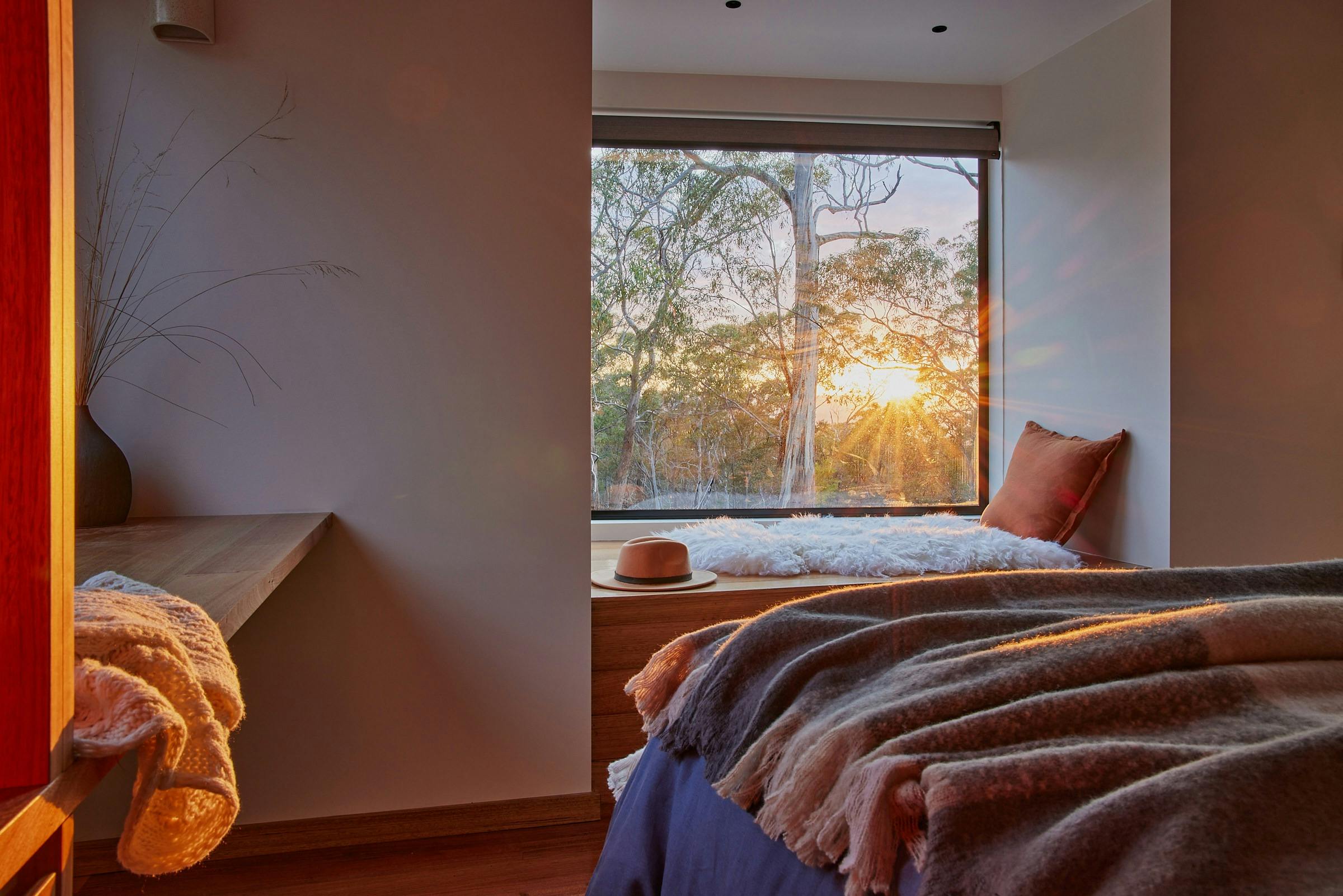 Morning sun shining through window onto day bed and bedroom