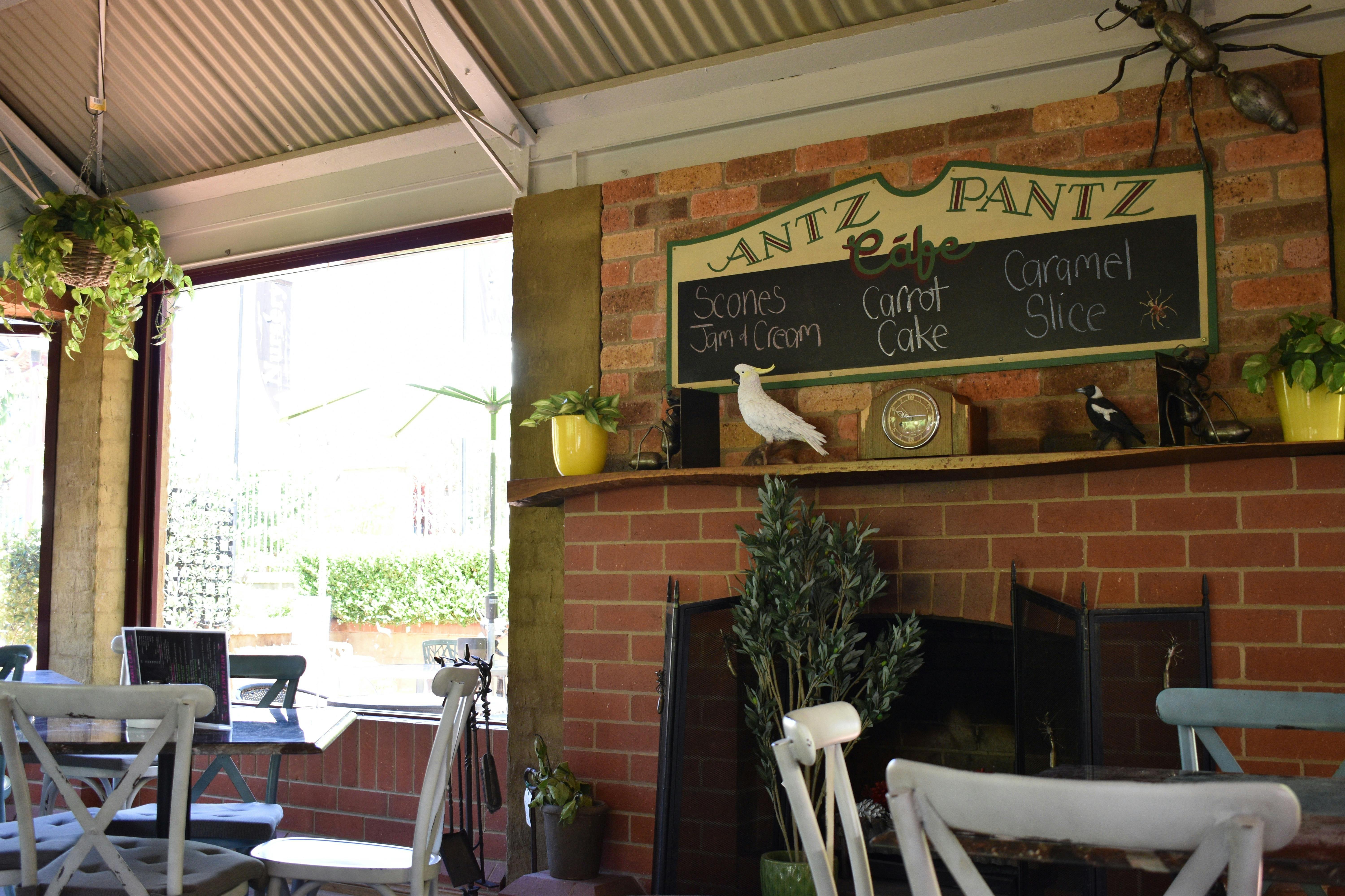 Inside the cafe: a fireplace and dining tables.