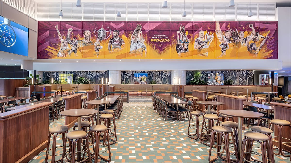 A large bar area with a Broncos mural