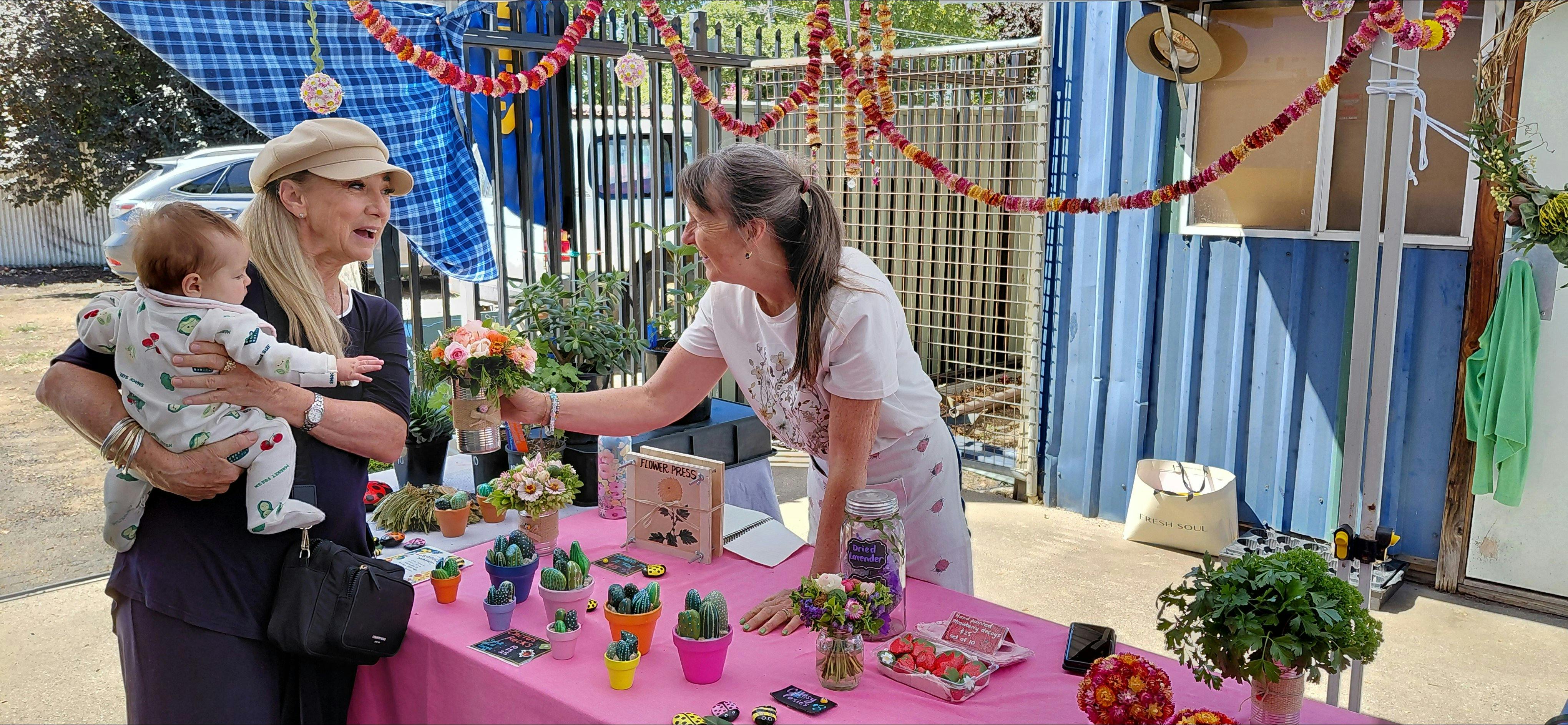 Tara of Ladybird flowers and plants chatting to a customer.