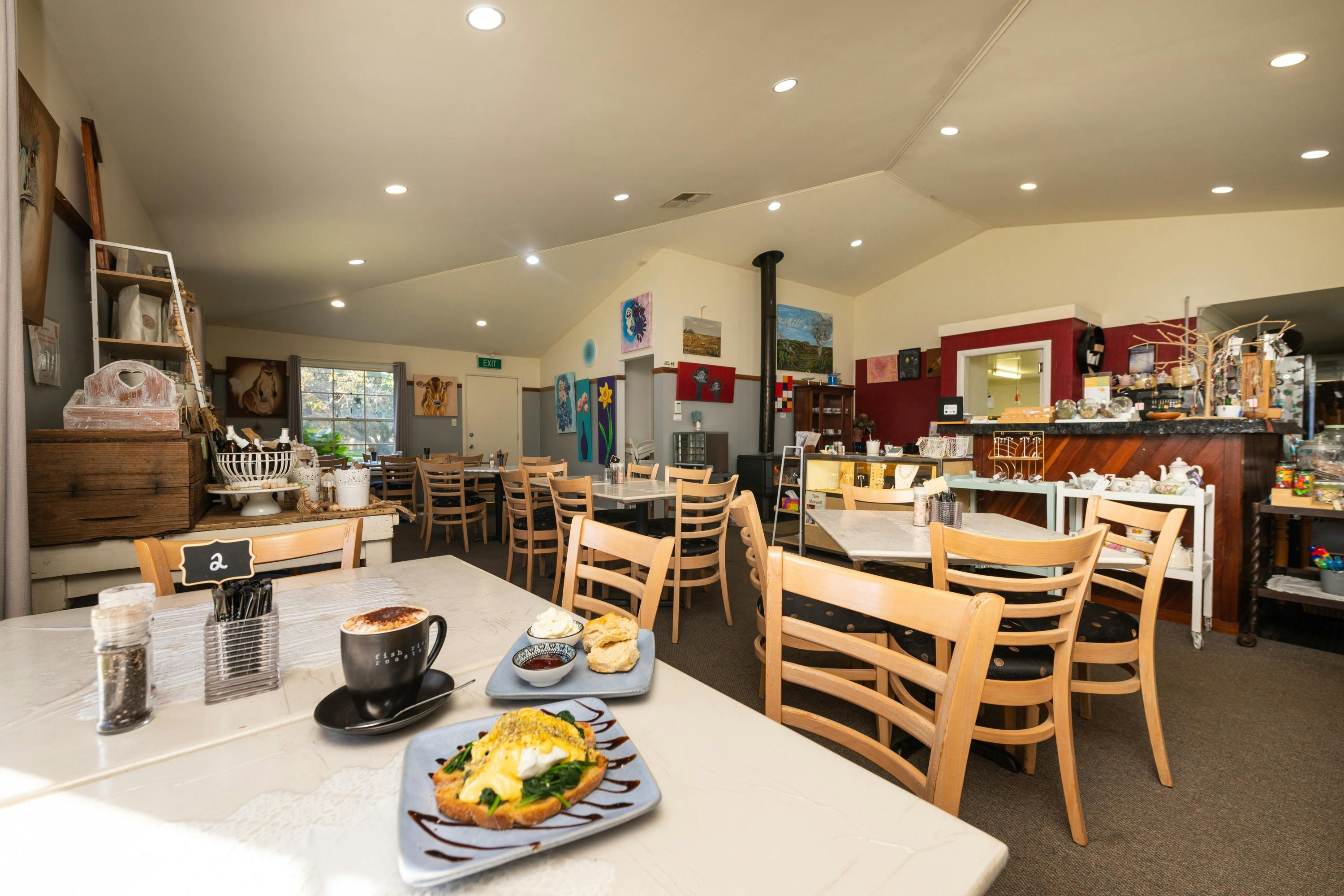 Wide view with food on the table and the rest of the cafe's dining area.