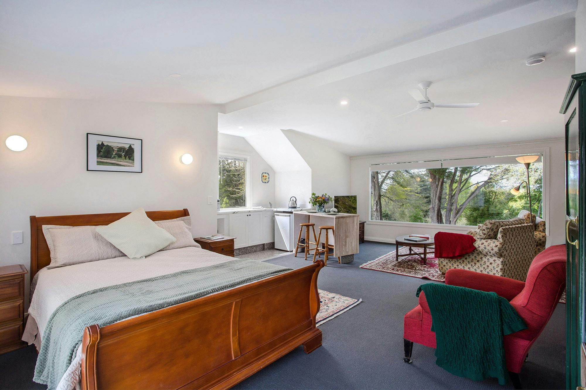 View of bed area to kitchenette and living area