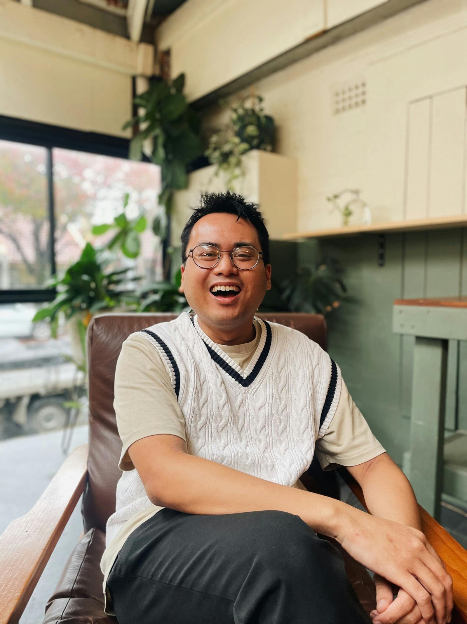 A man laughing in a cafe