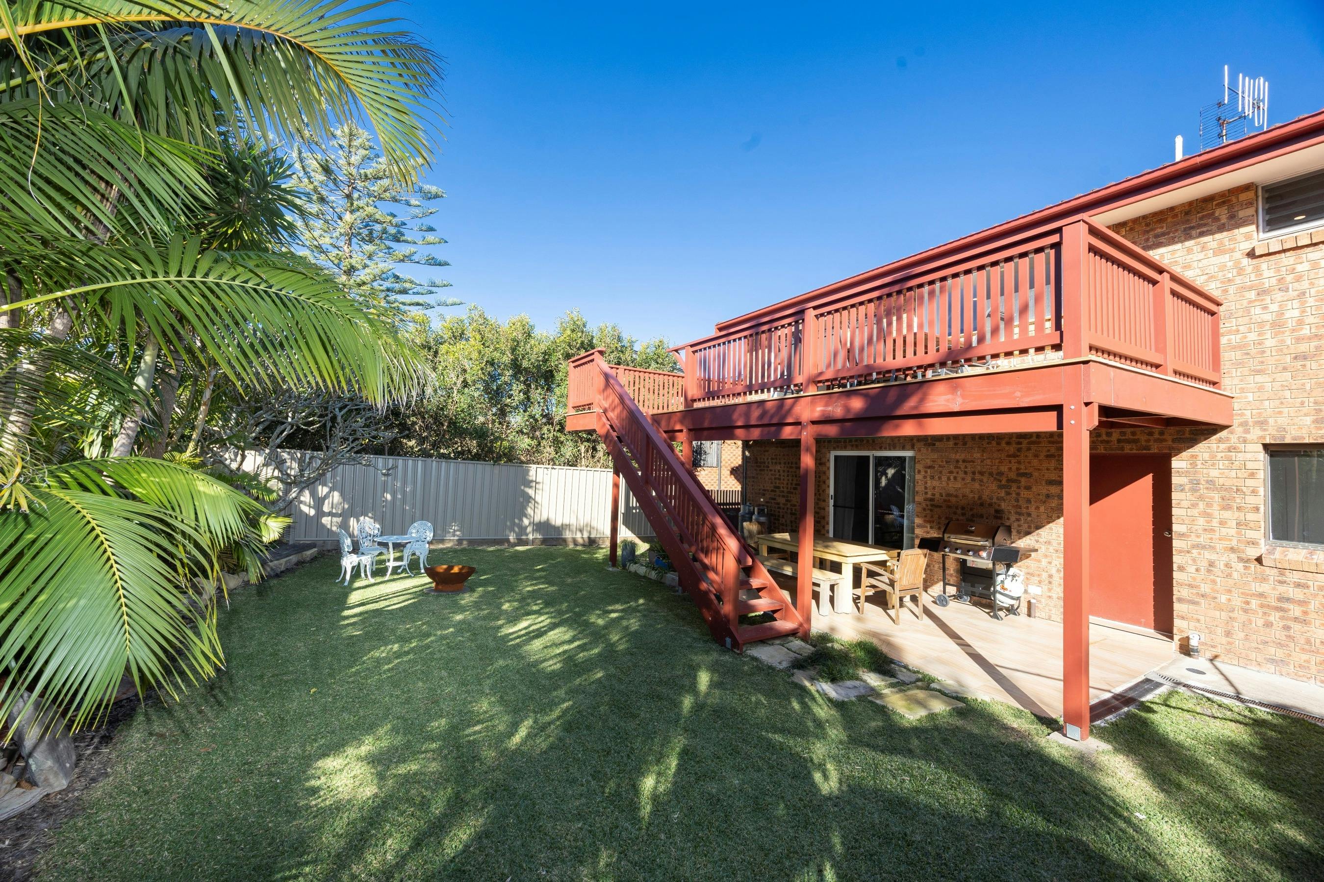 Backyard with patio, dining setting, barbeque and fire pit