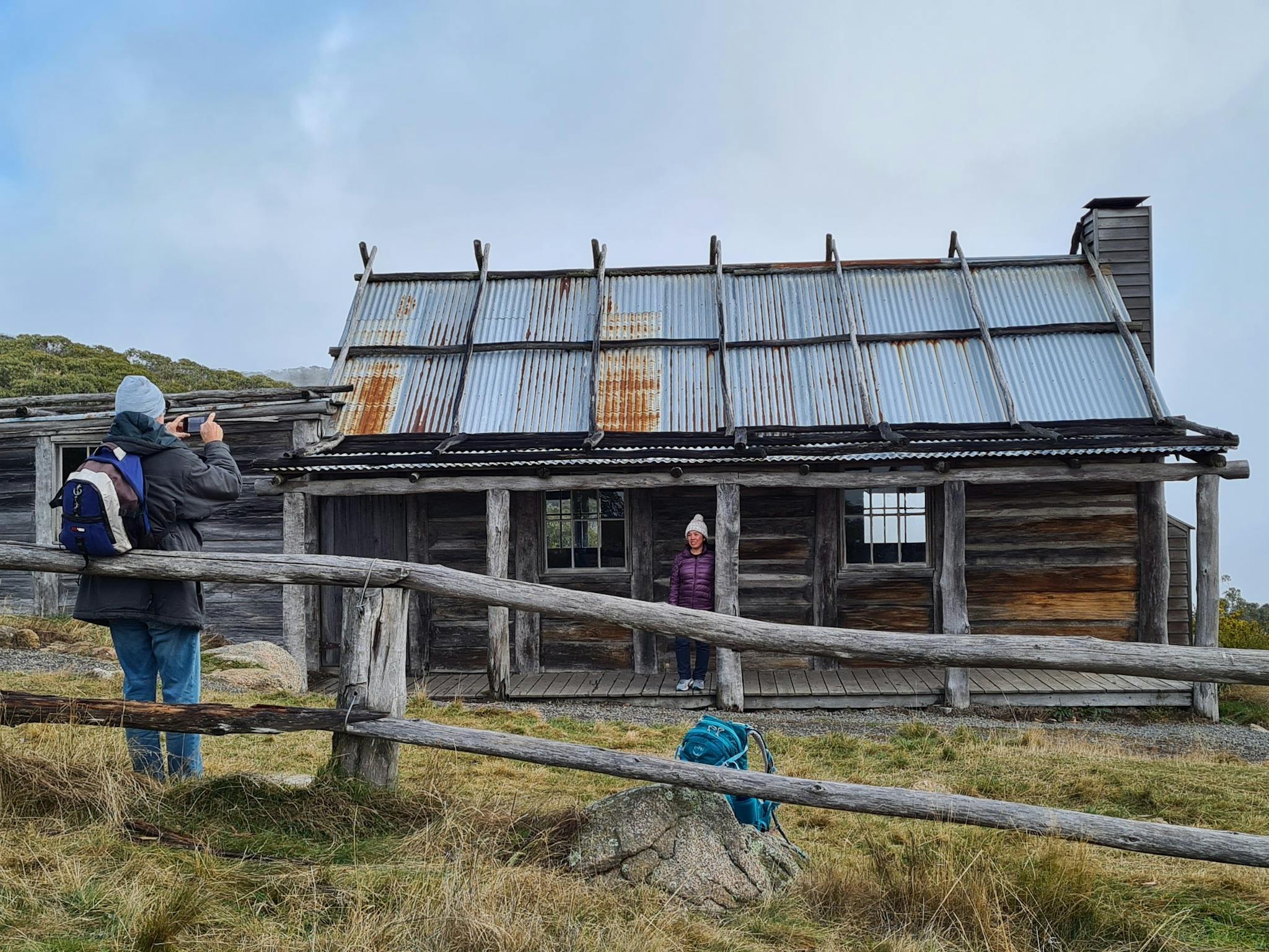 A couple of hikers capturing the magic of Craig's Hut on their camera.