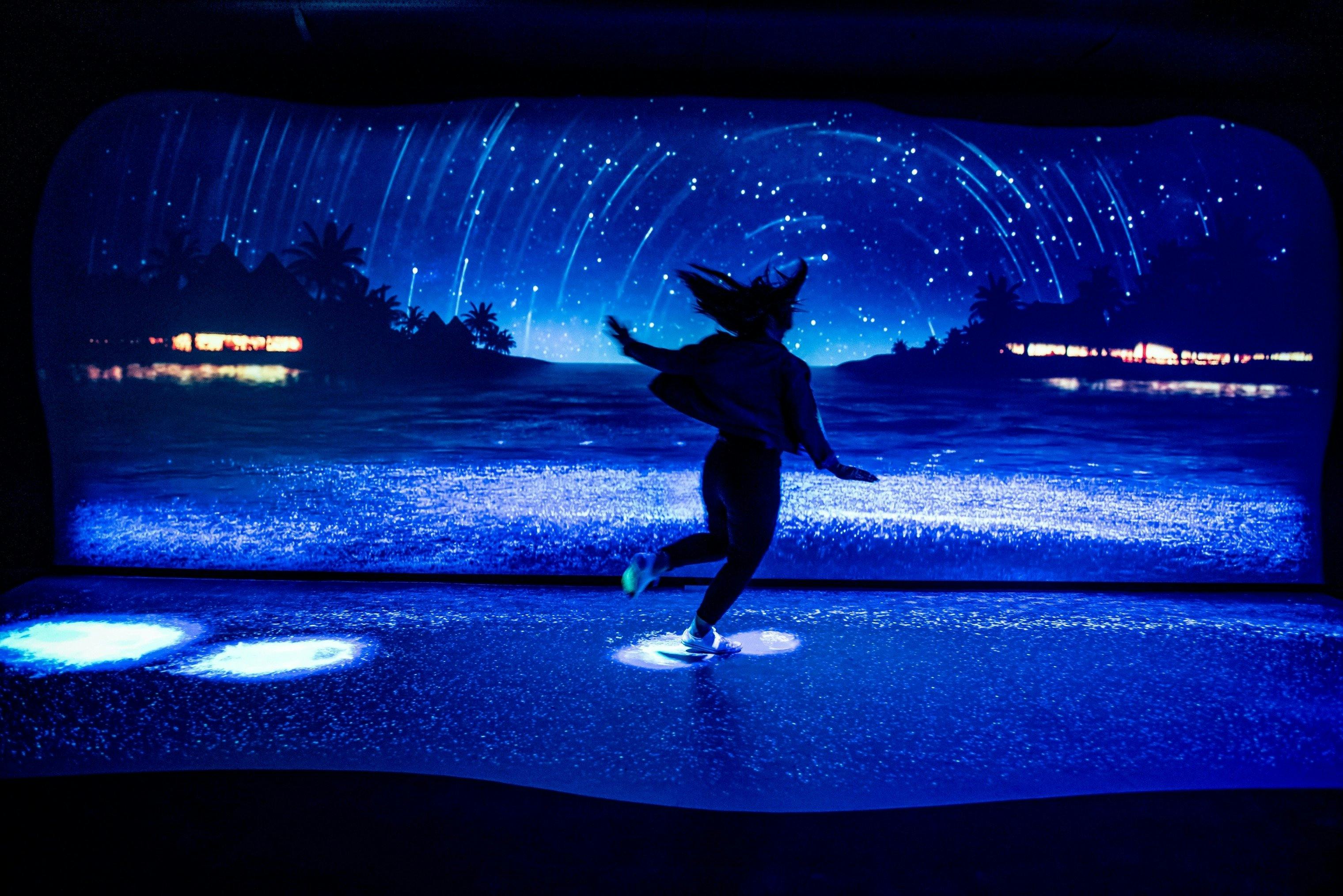 A bioluminescent ocean glows under guest’s footsteps at 'night'