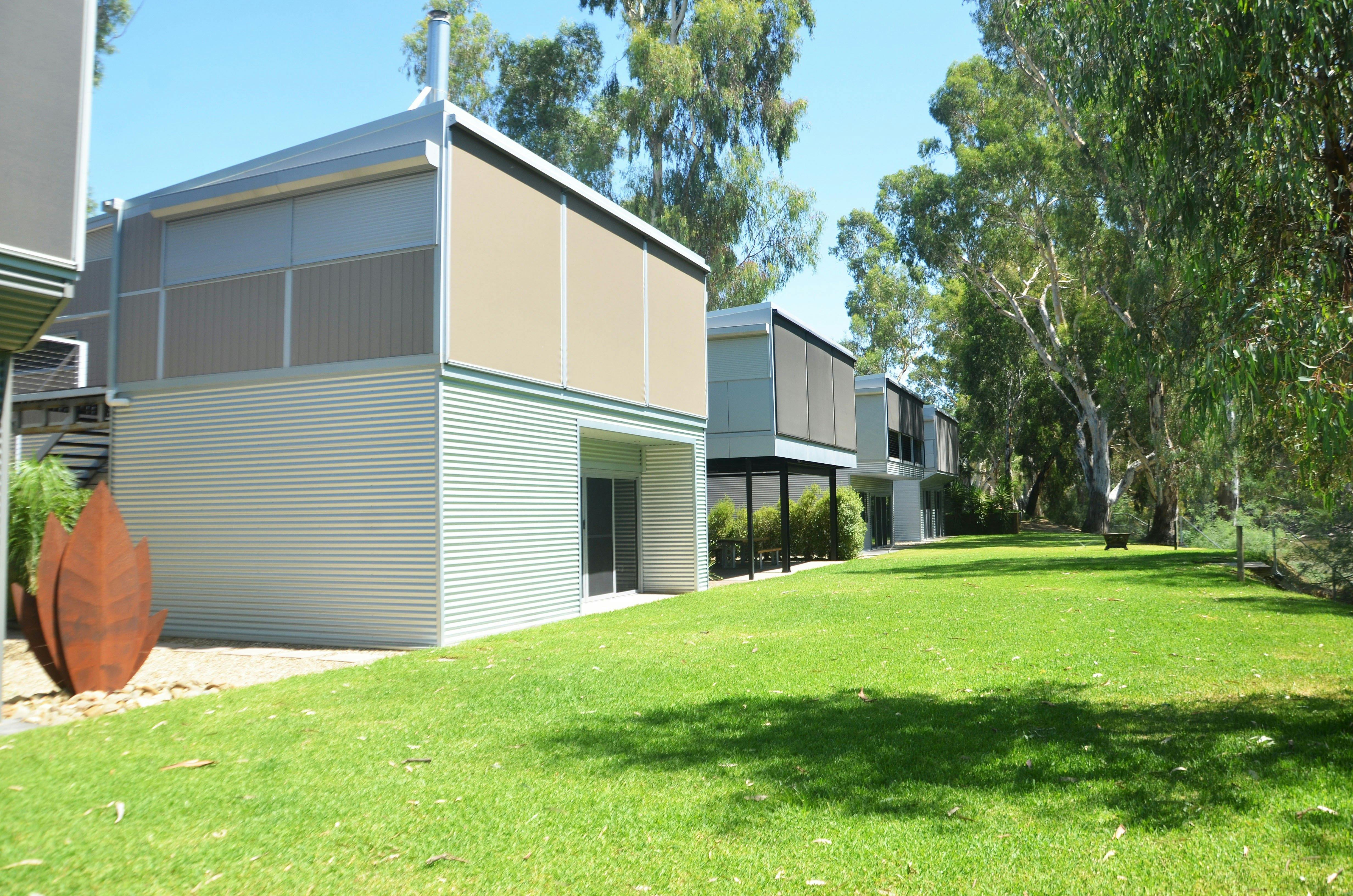 Double story cabins with green front lawn