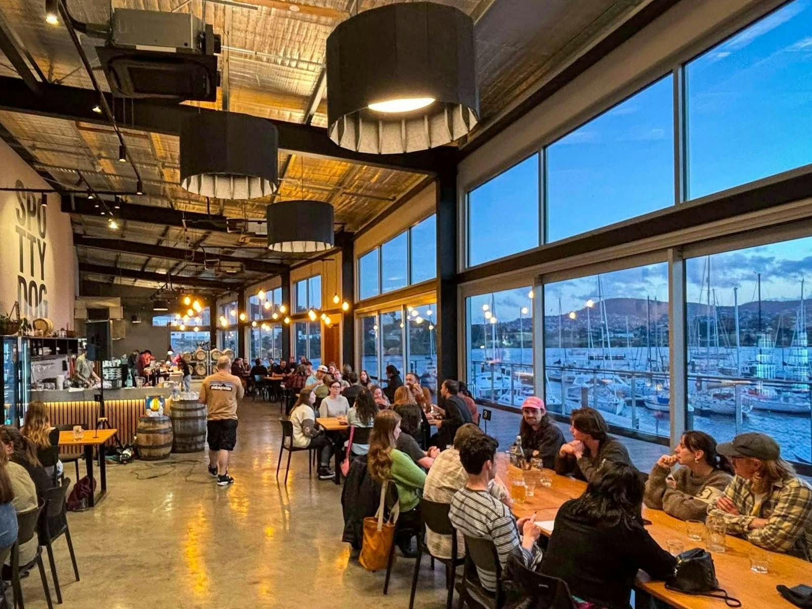 Inside the Spotty Dog Brewery and Taphouse. People enjoying food, drink and company.