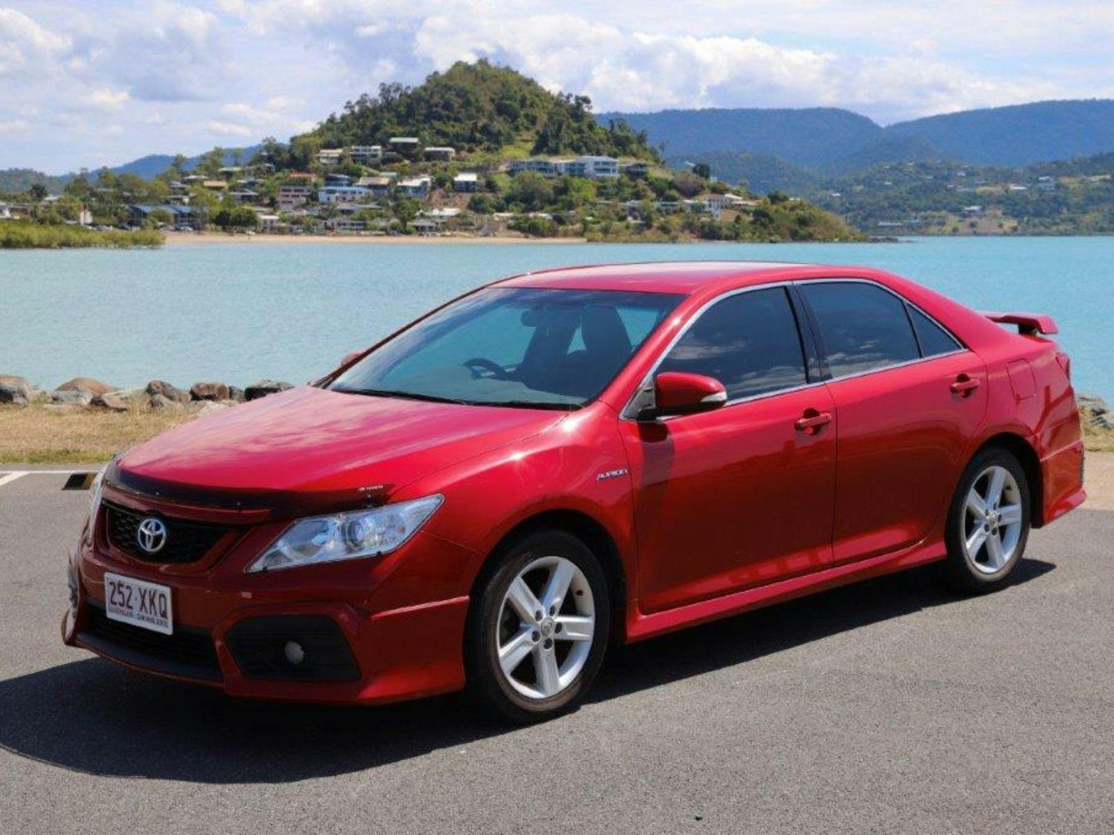 Heart of Reef Car for rent in front of Airlie Beach Background