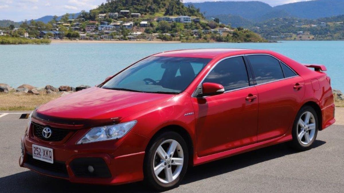 Heart of Reef Car for rent in front of Airlie Beach Background