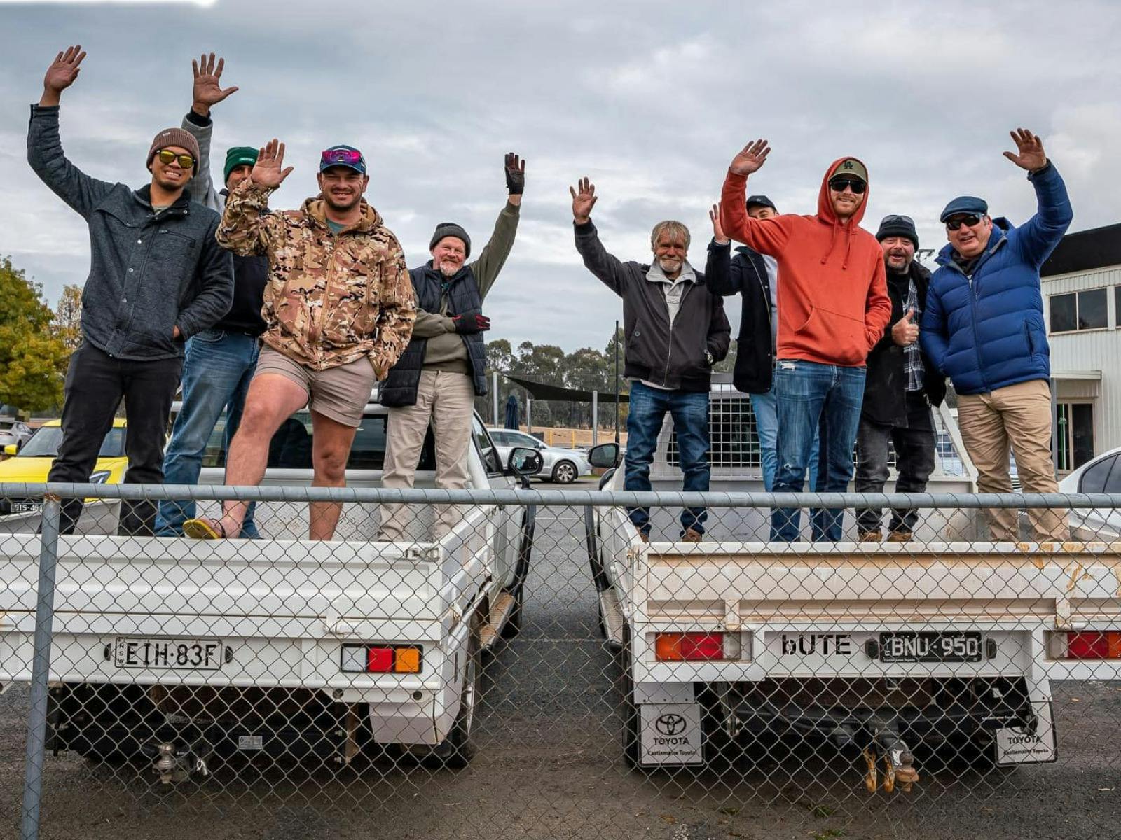 Group of people on the back of 2 utes