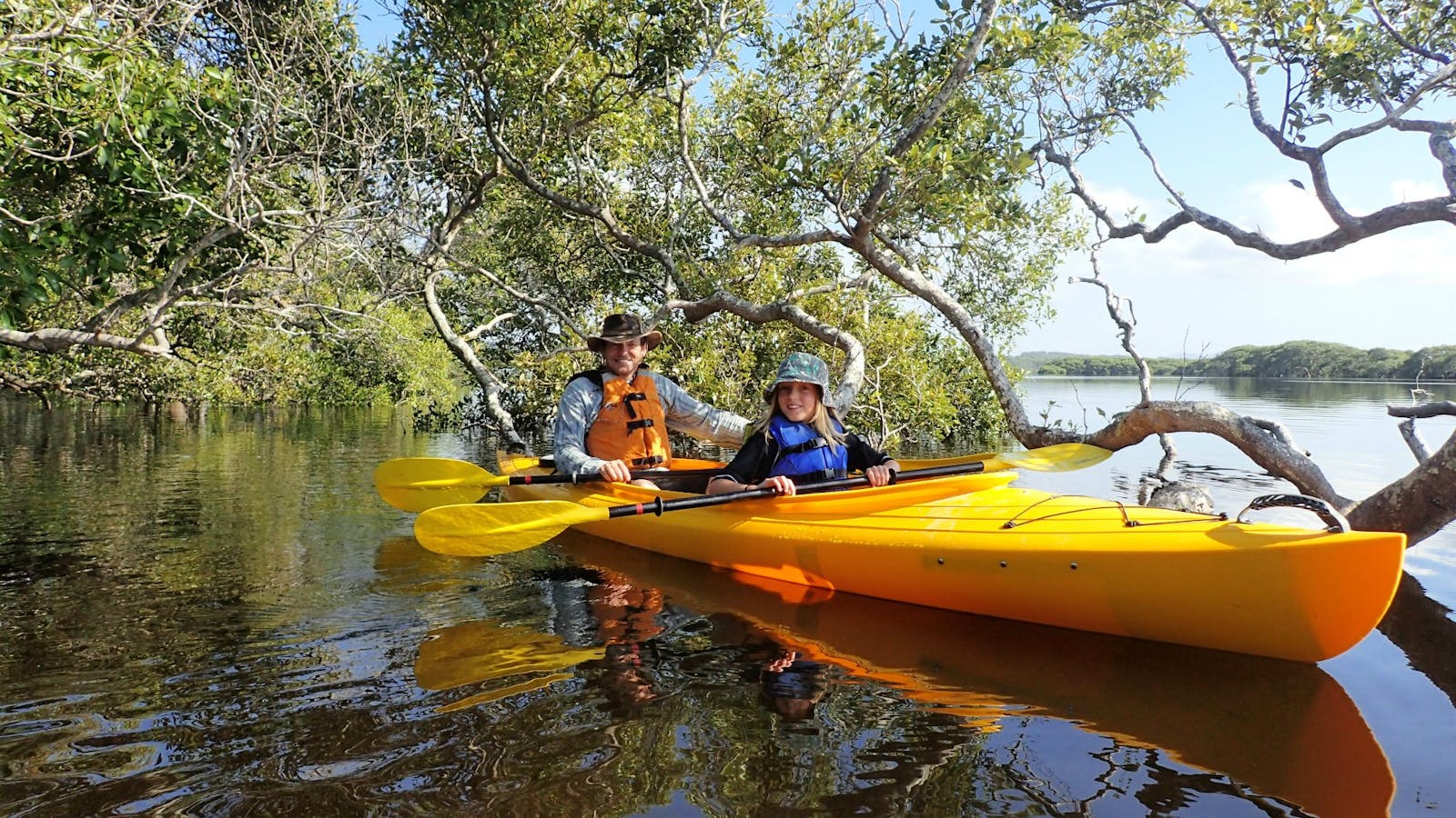 Father and son enjoying a guided kayak tour with Lazy Paddles