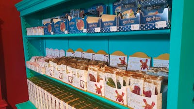 Shelves full of lollies, including chocolate frogs.,