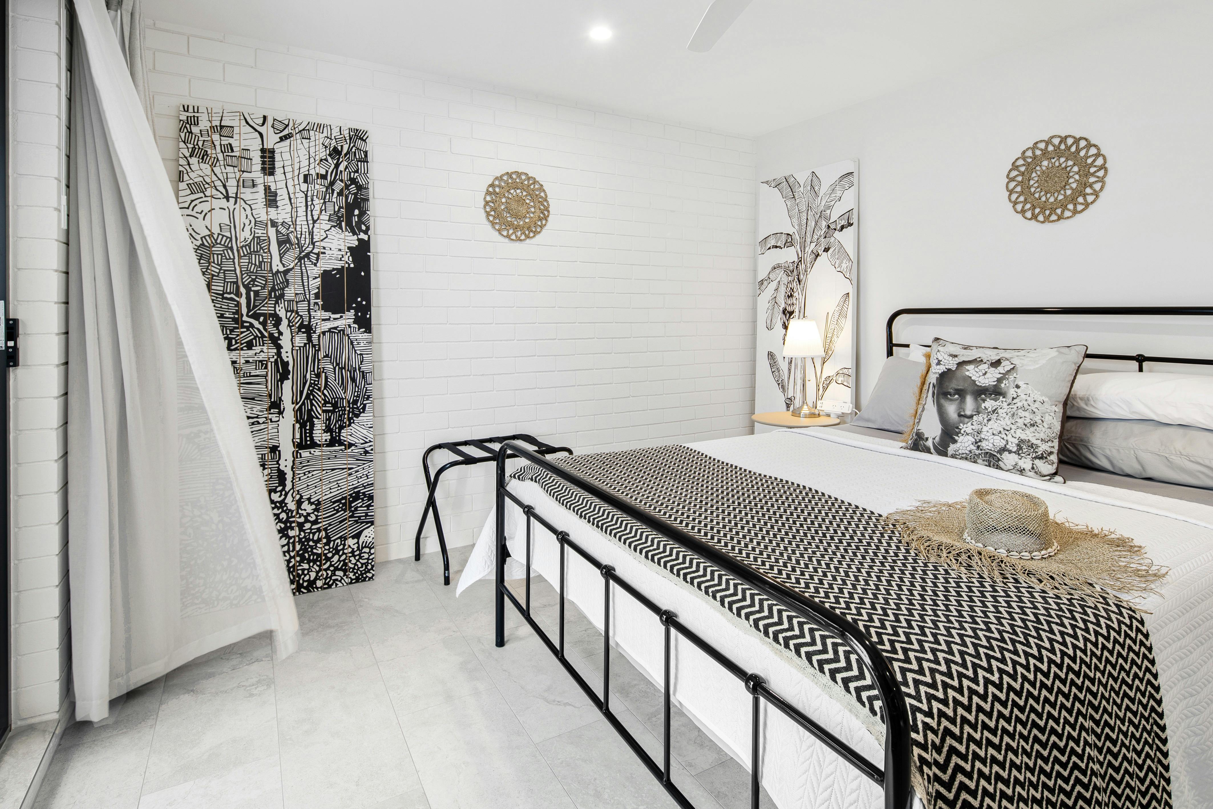 Main bedroom with queen bed and art by the owner