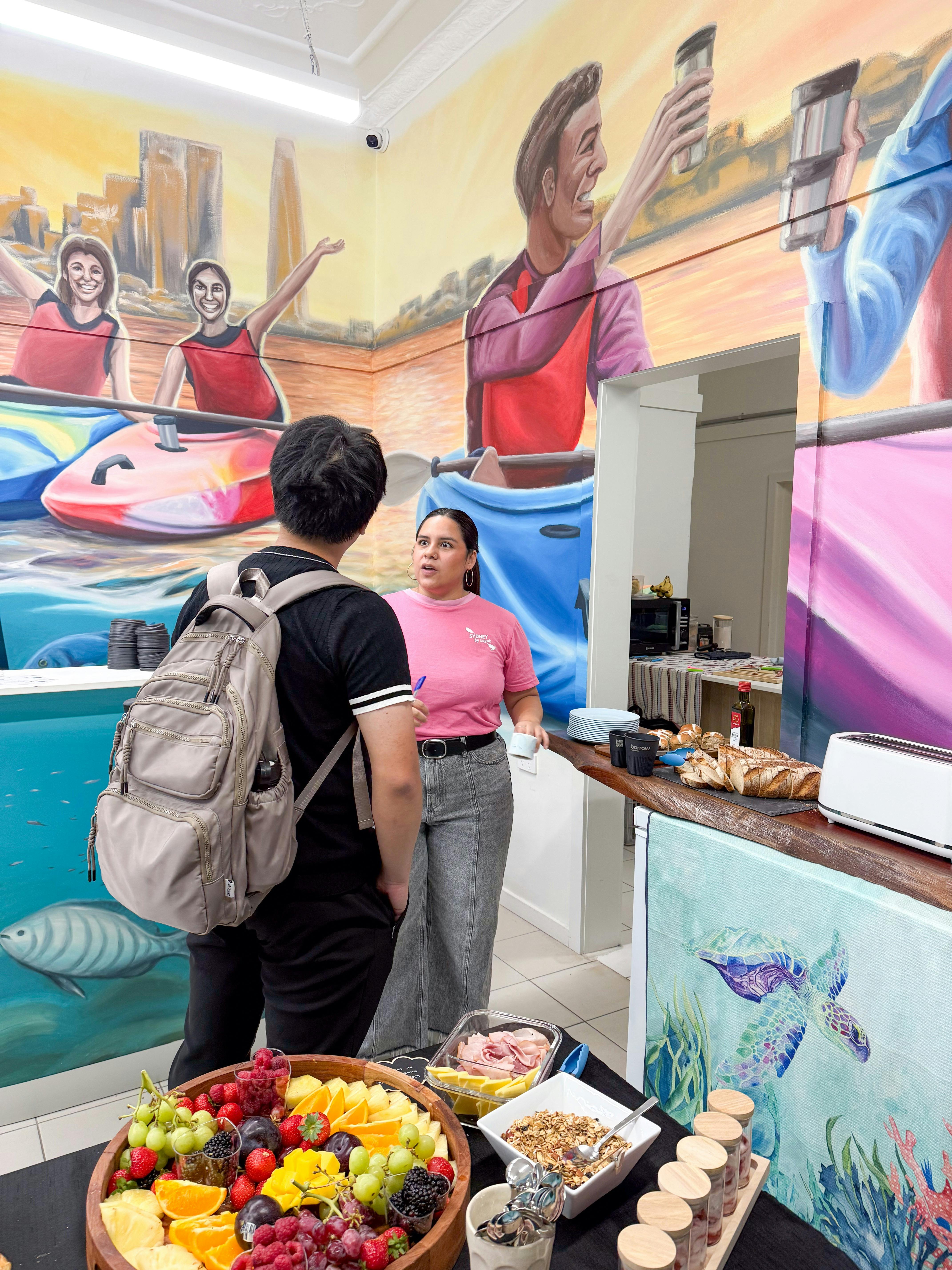 SBK Eco Hub staff member helps customer get the information they need about Sydney and things to do.