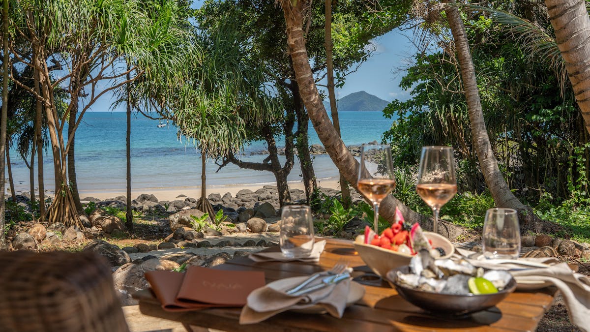Outdoor dining at Nala Resort,  Tropical drinks, curated wine list with views of Dunk Island
